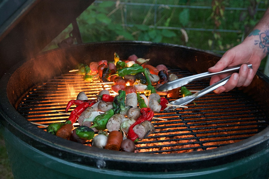 charcoal grill with Loukaniko Greek-style sausage kebabs grilling