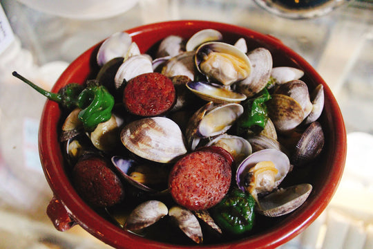 Manila clams with smoked chorizo, padrons, and garlic toast