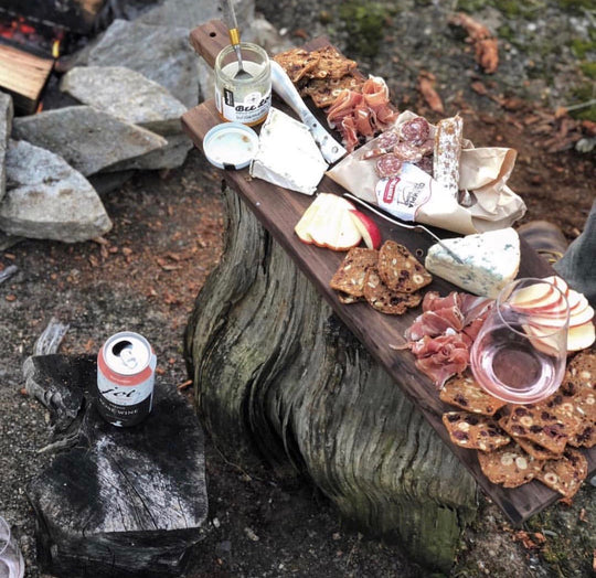 a charcuterie board at an outdoor campfire party