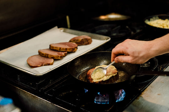 ham being cooked with Pfriem beer to make a soup