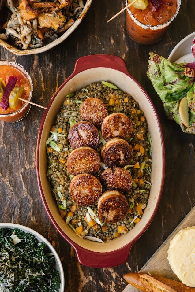 Cooked cotechino and lentils in a casserole dish
