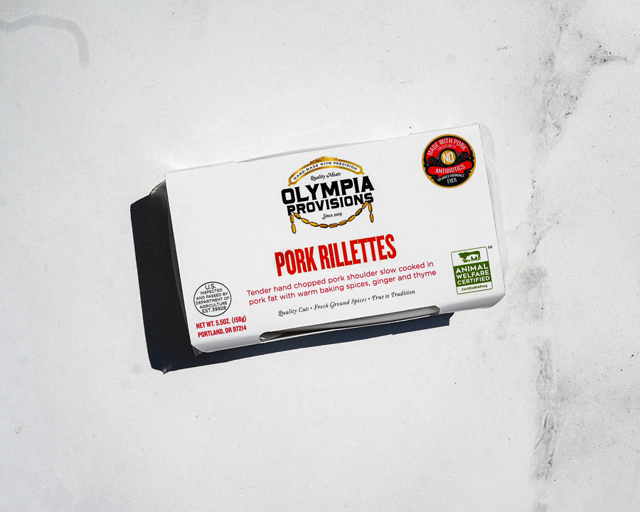 Box of Olympia Provisions Pork Rillettes on a marble surface