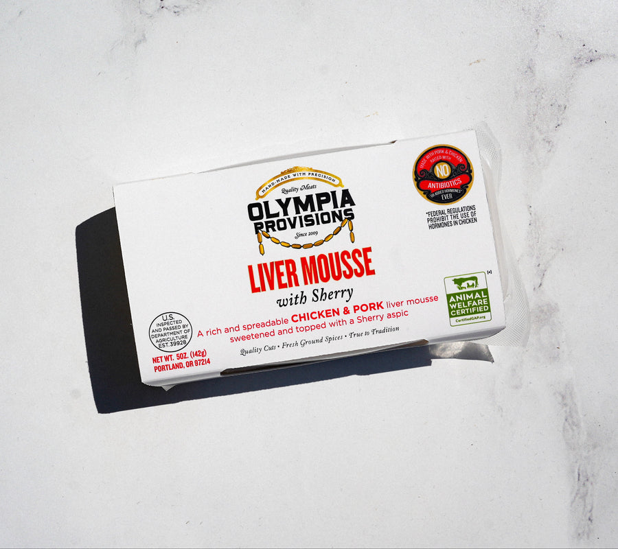 Packaged liver mousse with sherry from Olympia Provisions on a white marble surface
