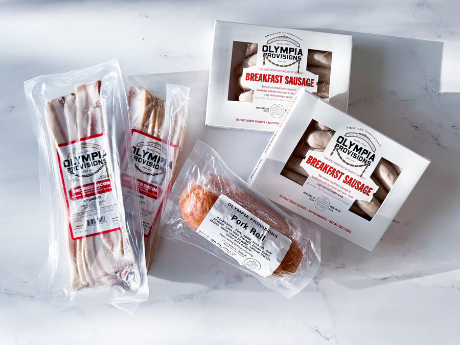 two packs of olympia proisions breakfast sausage and two packs of olympia provions uncured bacon and on olympia provions pork roll
