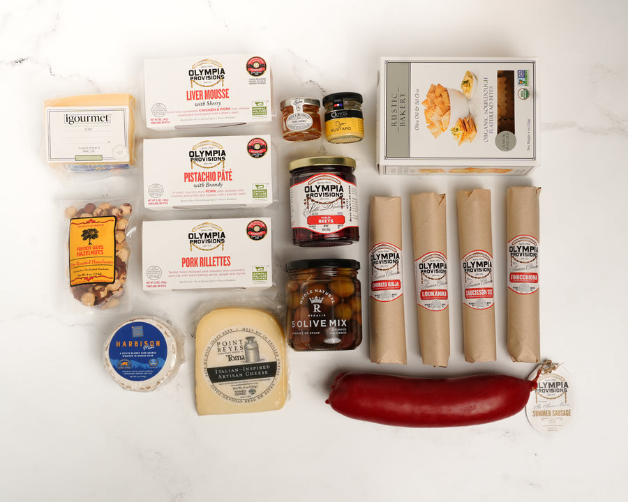 Assorted salami, pate, cheese, honey, mustard, olives, on a white background