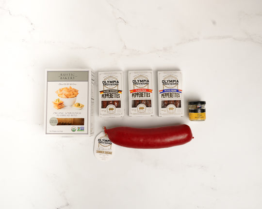 Olympia Pepperettes with a large red pepper on a white background