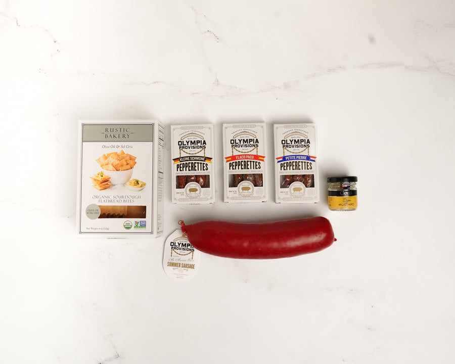 Olympia Pepperettes with a large red pepper on a white background