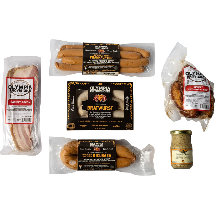 Assorted Olympia Provisions sausages, ham, bacon, mustard on a white background.