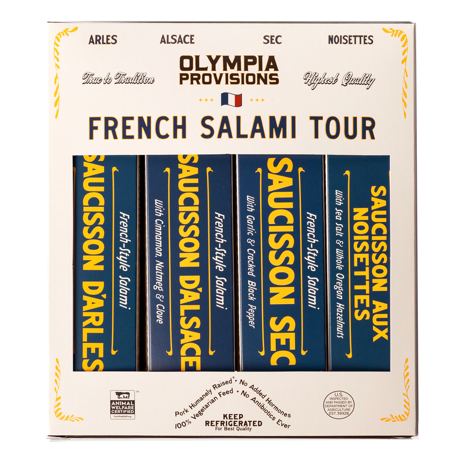 Four Olympia Provisions French-inspired salamis in blue boxes, packed in a cream box labelled "French Salami Tour"