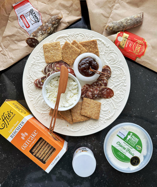 spring charcuterie board wth salami, cheese, jam and crackers